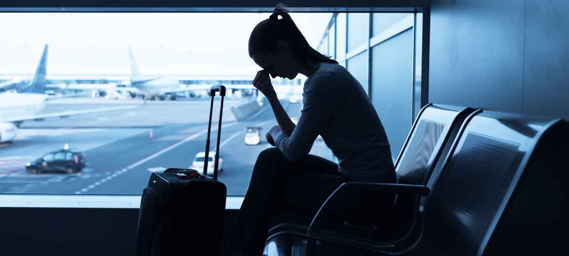 Women business traveler at airport exhausted from Jet Lag